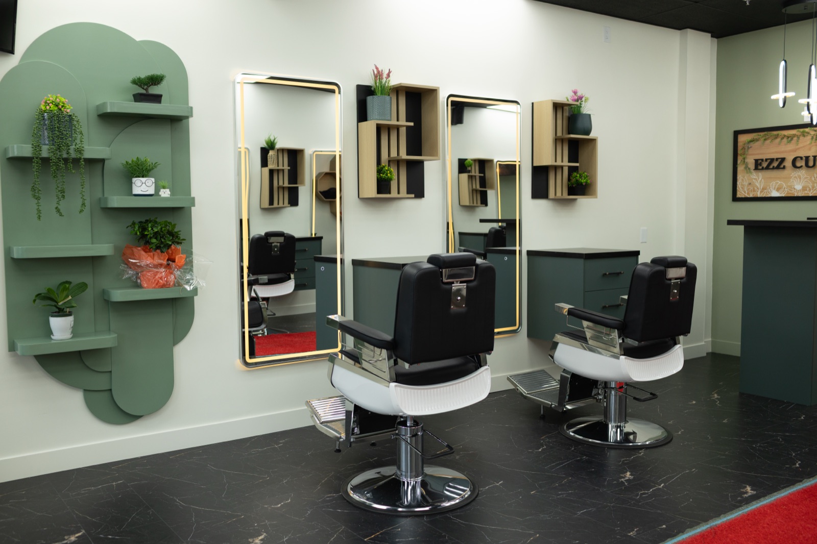 Barber chairs and gold-framed mirror stations at Ezz Cutz
