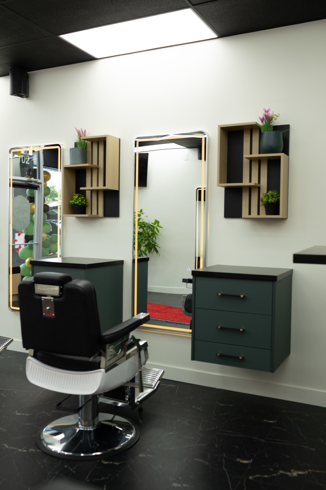 A barber chair and mirror station at Ezz Cutz